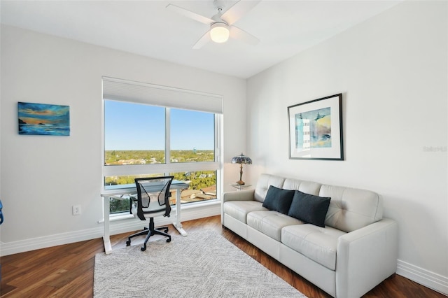 office area featuring baseboards, a ceiling fan, and plenty of natural light