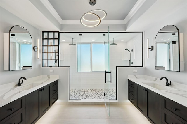 bathroom with two vanities, a sink, and a stall shower