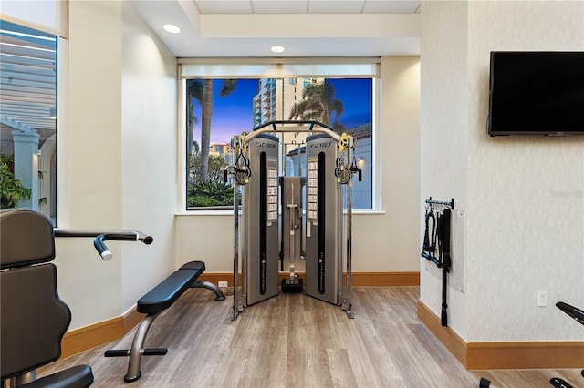 workout area featuring baseboards, recessed lighting, and wood finished floors