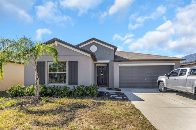 single story home with concrete driveway, an attached garage, and stucco siding