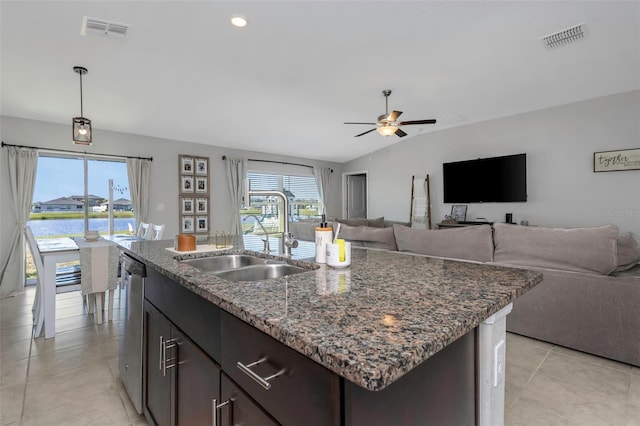 kitchen with stainless steel dishwasher, visible vents, open floor plan, and a sink