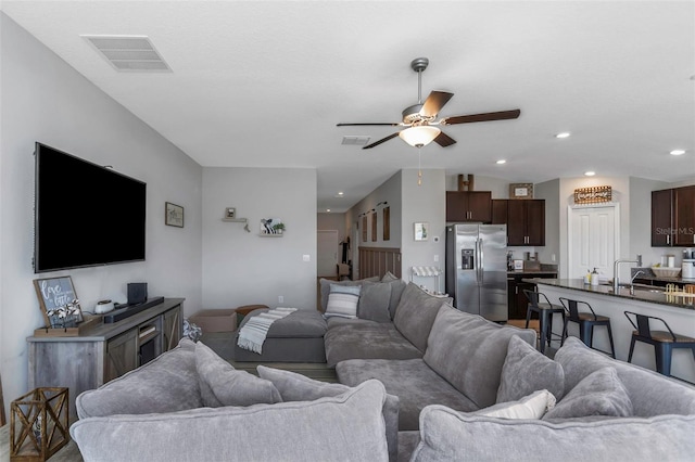 living area with recessed lighting, vaulted ceiling, visible vents, and ceiling fan