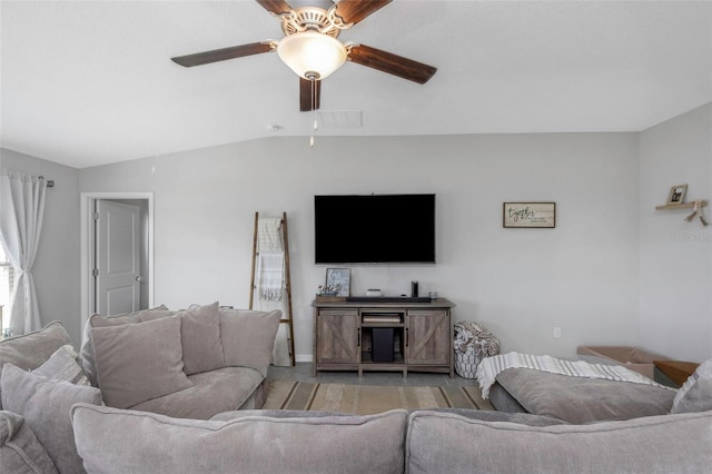 living area featuring light wood-style floors, visible vents, vaulted ceiling, and a ceiling fan