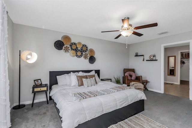 carpeted bedroom featuring baseboards, visible vents, and a ceiling fan