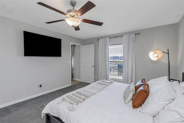 carpeted bedroom featuring baseboards and a ceiling fan