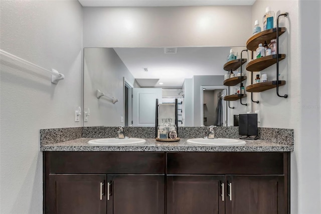 full bath featuring double vanity and a sink