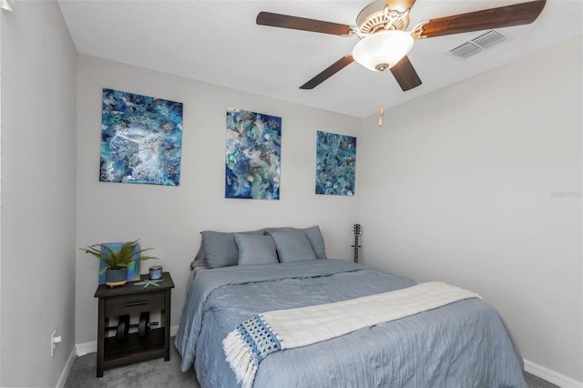 carpeted bedroom featuring baseboards, visible vents, and a ceiling fan