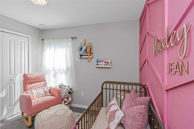 carpeted bedroom featuring a closet and baseboards