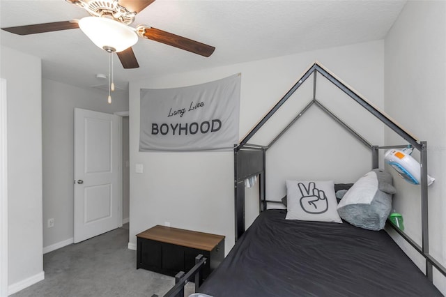 carpeted bedroom featuring a ceiling fan and baseboards