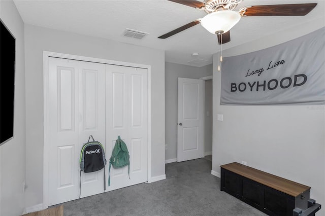 bedroom with baseboards, visible vents, ceiling fan, carpet flooring, and a closet