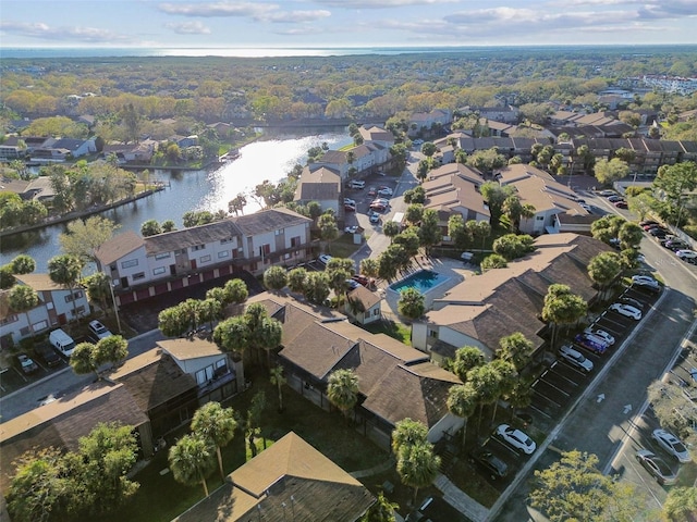 birds eye view of property with a water view and a residential view