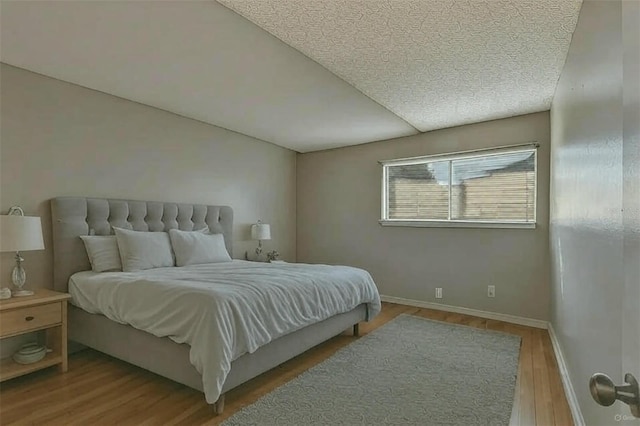 6330 Newtown Cir Unit 30B4, Tampa, FL 33615 - bedroom with a textured ceiling, wood finished floors, and baseboards