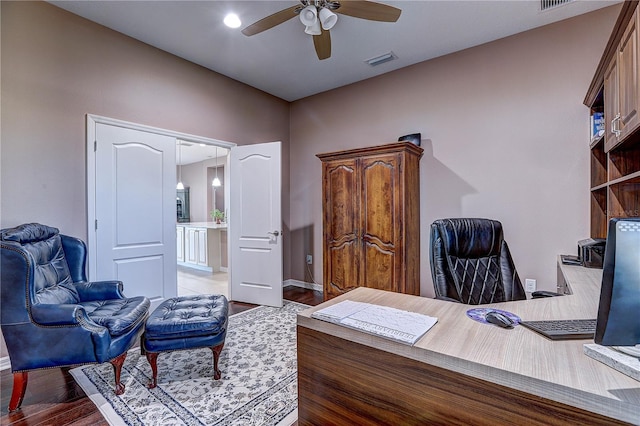 home office featuring visible vents, ceiling fan, and wood finished floors