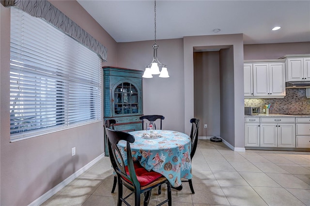 dining space with light tile patterned floors and baseboards