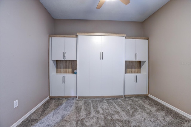 unfurnished bedroom featuring carpet, baseboards, and ceiling fan