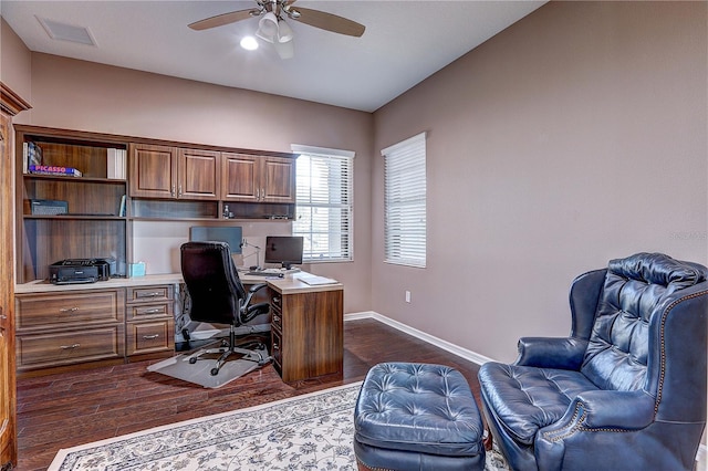 office space with visible vents, dark wood finished floors, baseboards, and ceiling fan