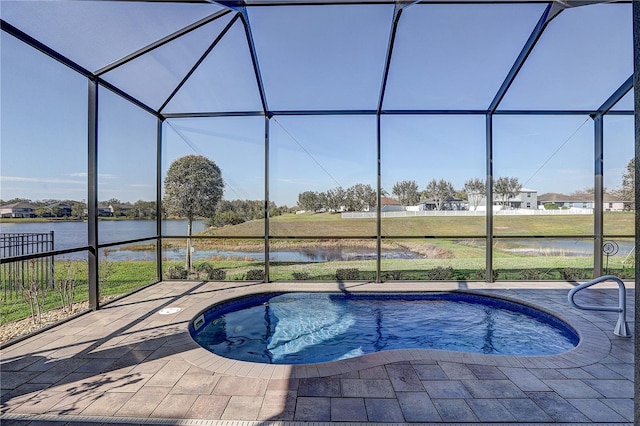 pool featuring a water view, glass enclosure, and a patio