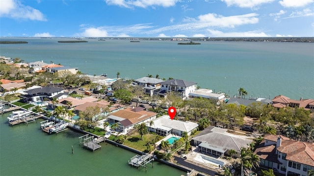 drone / aerial view featuring a residential view and a water view