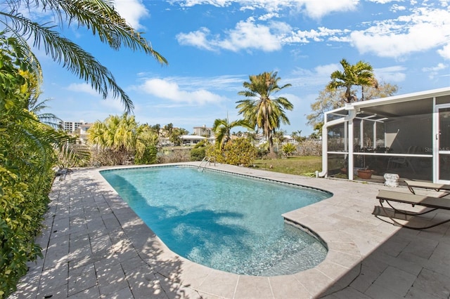 outdoor pool with a lanai and a patio