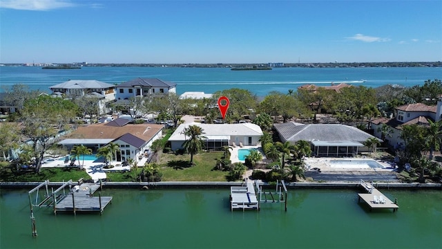 drone / aerial view featuring a water view and a residential view