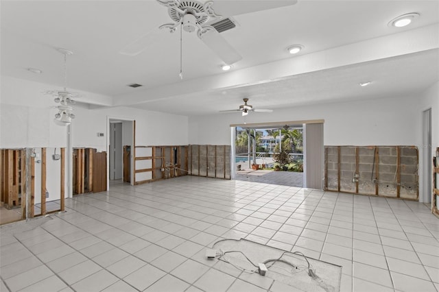 empty room with ceiling fan, visible vents, and tile patterned floors