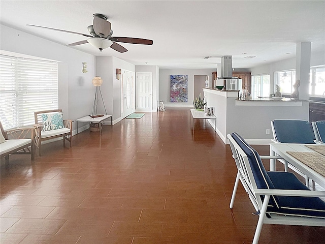 interior space with a ceiling fan and baseboards