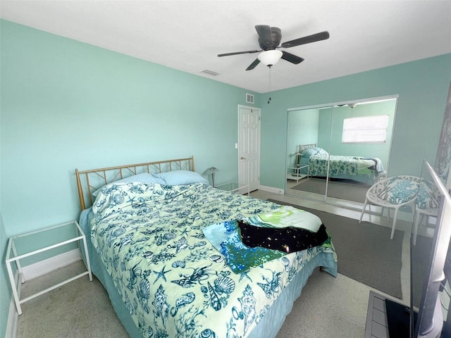 carpeted bedroom featuring a ceiling fan, a closet, visible vents, and baseboards