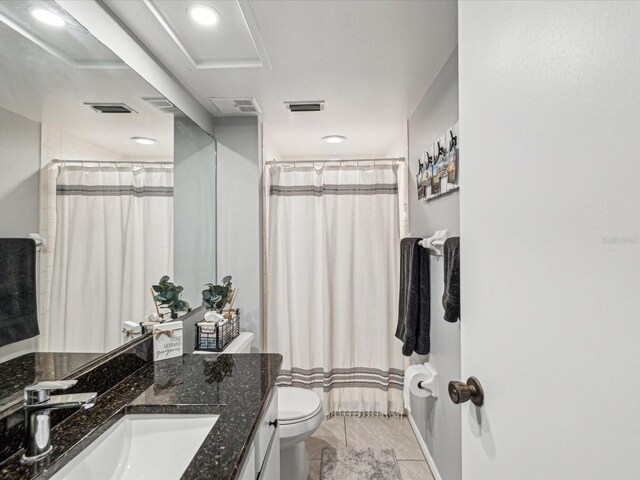 bathroom featuring toilet, tile patterned flooring, visible vents, and vanity