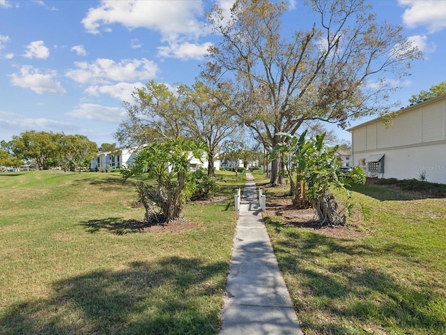 view of property's community with a yard