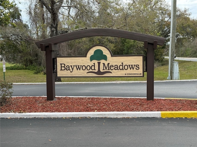 community sign featuring a carport