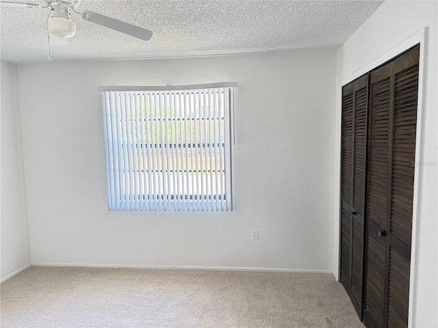 12155 Environmental Dr Unit 6, New Port Richey, FL 34654 - unfurnished bedroom with carpet, baseboards, a textured ceiling, and a closet