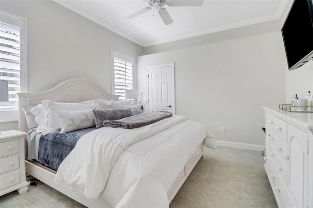 bedroom with baseboards, ceiling fan, ornamental molding, and light colored carpet