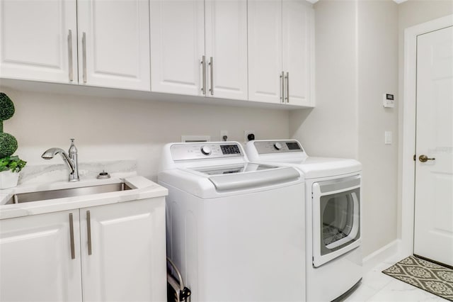 clothes washing area featuring marble finish floor, cabinet space, a sink, washer and dryer, and baseboards