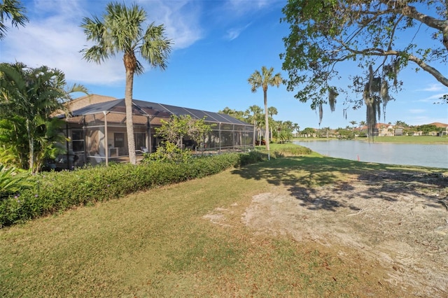 view of yard with a lanai and a water view