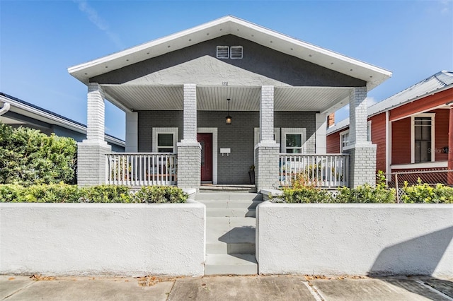 view of front of house with covered porch and brick siding