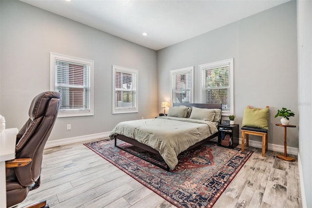 bedroom featuring recessed lighting, light wood-style flooring, and baseboards