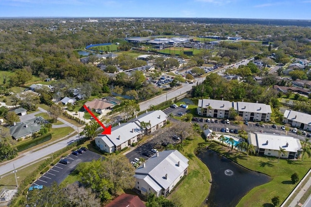 drone / aerial view with a water view and a residential view