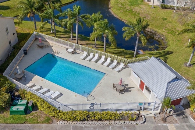 pool featuring fence private yard, a water view, and a patio