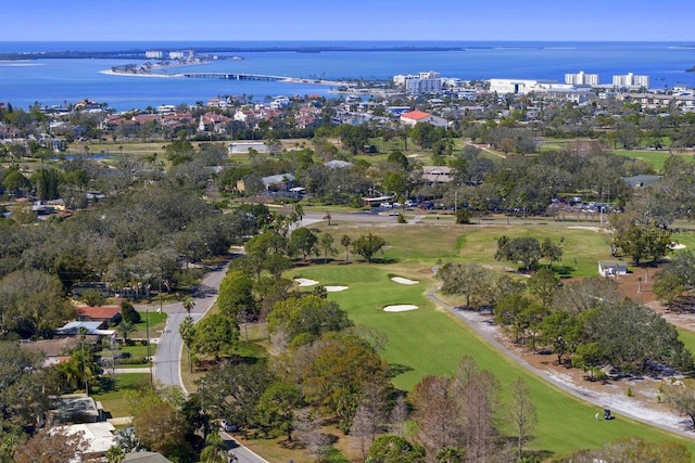 birds eye view of property with a water view and view of golf course