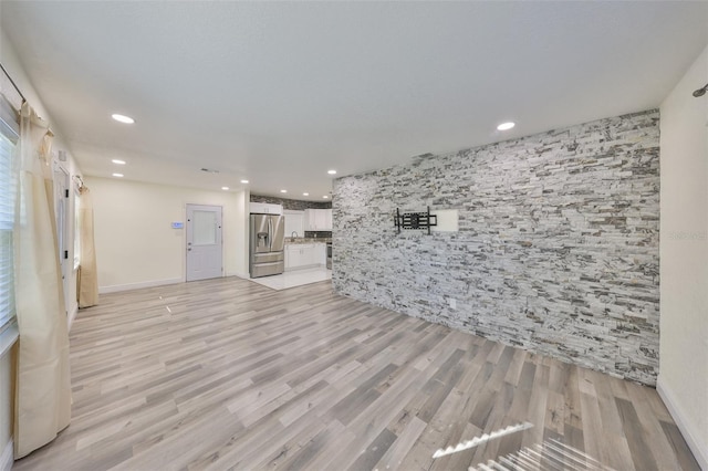 unfurnished living room with light wood-style flooring and recessed lighting