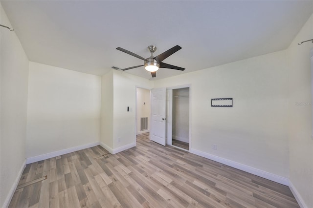 unfurnished bedroom with light wood-style flooring, a closet, visible vents, and baseboards