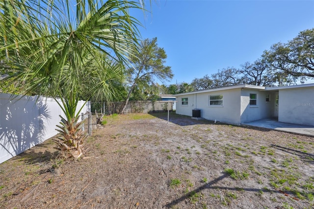 view of yard with central AC, a patio, and a fenced backyard