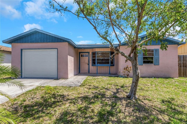 12704 128th Ln, Largo, FL 33774 - ranch-style home with driveway, stucco siding, a front yard, an attached garage, and fence