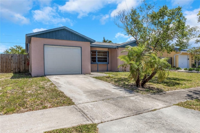 12704 128th Ln, Largo, FL 33774 - ranch-style house with driveway, stucco siding, fence, a front lawn, and a garage