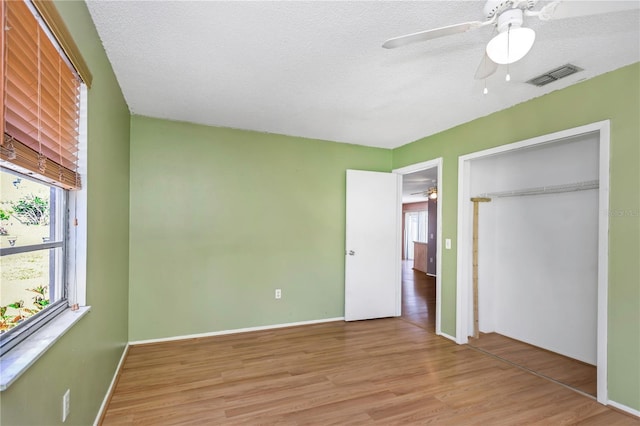 12704 128th Ln, Largo, FL 33774 - unfurnished bedroom featuring wood finished floors, visible vents, and multiple windows
