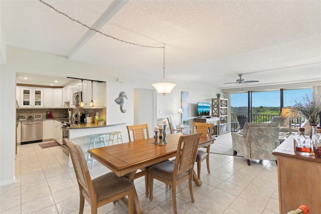 dining room featuring a ceiling fan, a textured ceiling, and light tile patterned floors