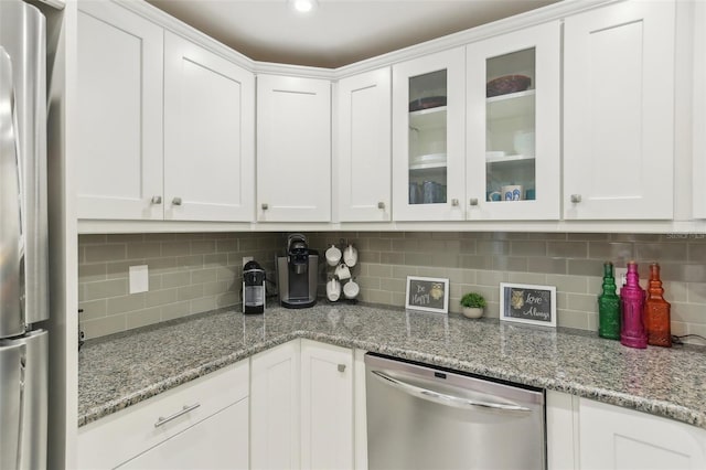 kitchen with stainless steel appliances, white cabinetry, glass insert cabinets, and backsplash