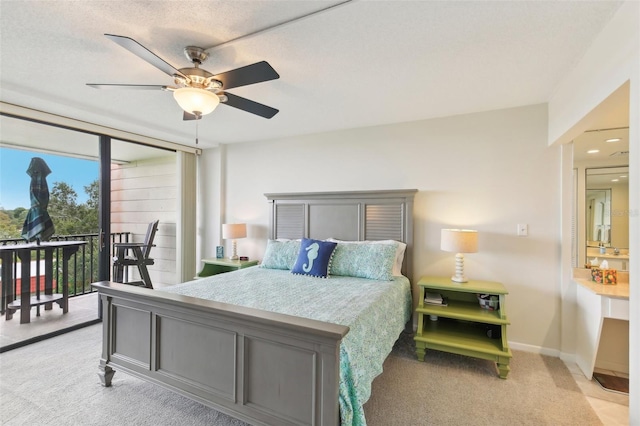 bedroom featuring a textured ceiling, ceiling fan, light colored carpet, baseboards, and access to outside