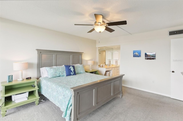 bedroom with light carpet, ceiling fan, visible vents, and baseboards