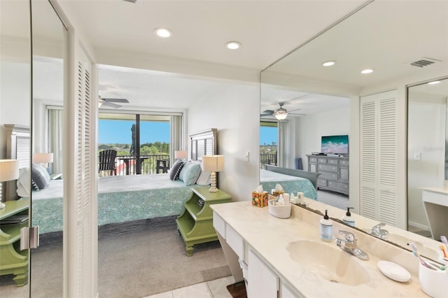 ensuite bathroom featuring ensuite bathroom, ceiling fan, recessed lighting, vanity, and a closet